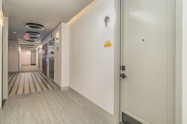 a view of hallway with wooden floor