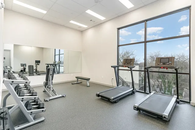 a room with gym equipment and a large window