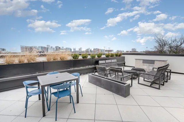 a view of a terrace with furniture and a fire pit