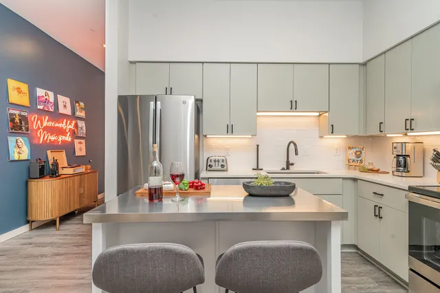 a kitchen with stainless steel appliances a stove refrigerator sink and cabinets