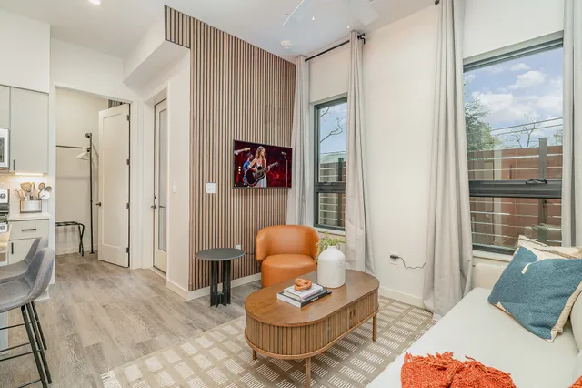 a living room with furniture and a wooden floor