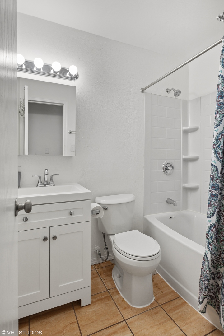 269 Seabury Road Bolingbrook, IL 60440 - Photo 7 of 21 a bathroom with a sink a toilet and a mirror
