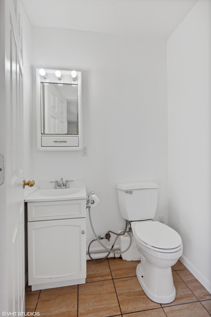 269 Seabury Road Bolingbrook, IL 60440 - Photo 8 of 21 a bathroom with a toilet a sink and mirror