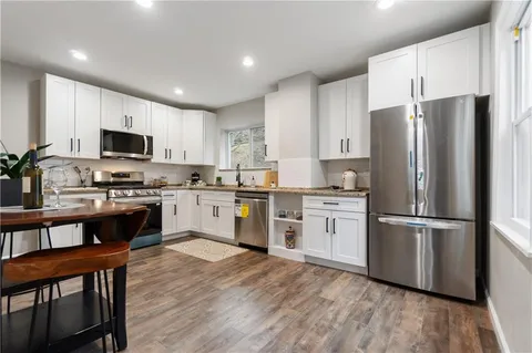 a kitchen with a refrigerator stove and microwave