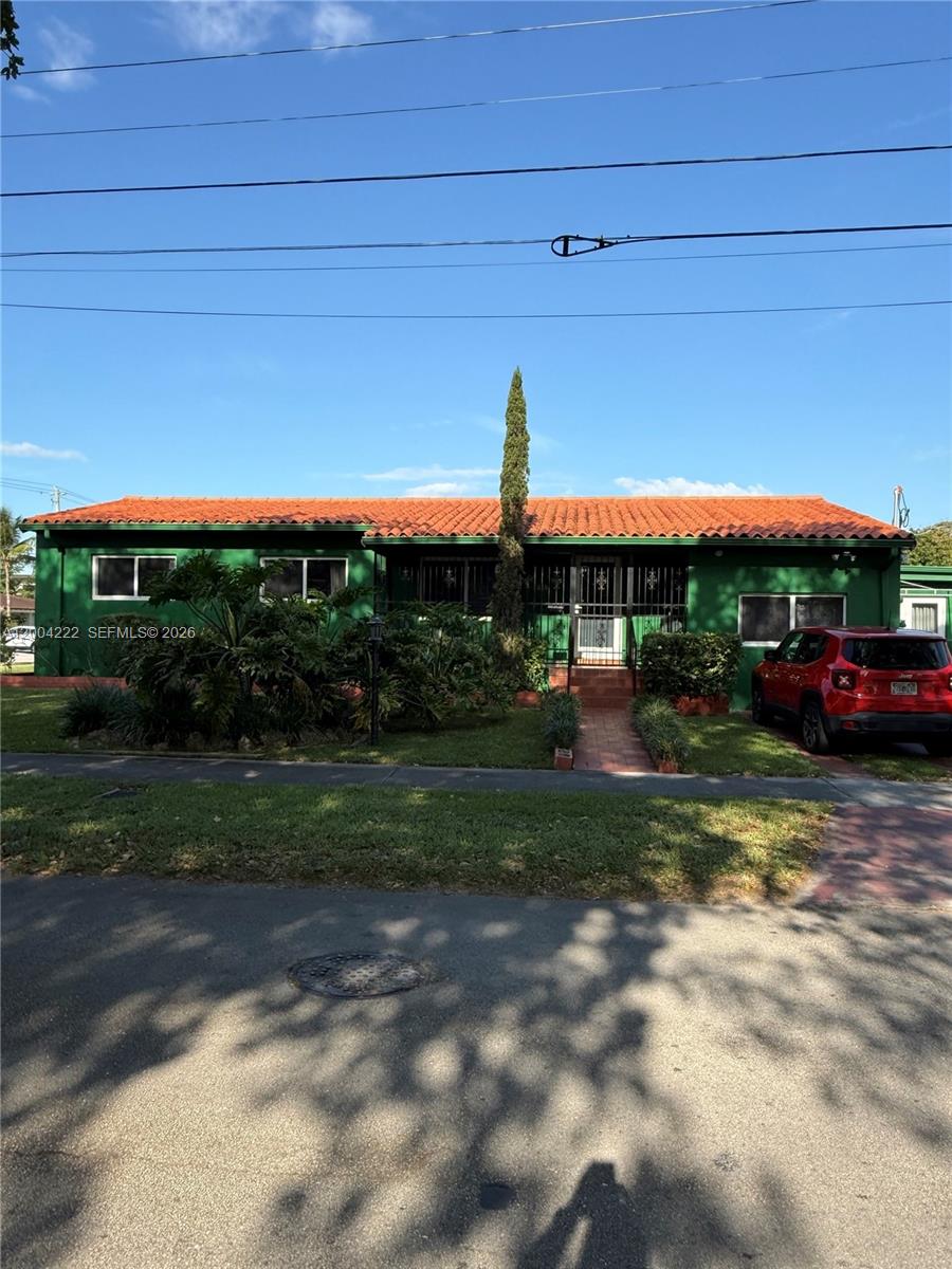 540 Southwest 39th Avenue Miami, FL 33134 - Photo 1 of 48 a view of a yard with table and chairs under an umbrella
