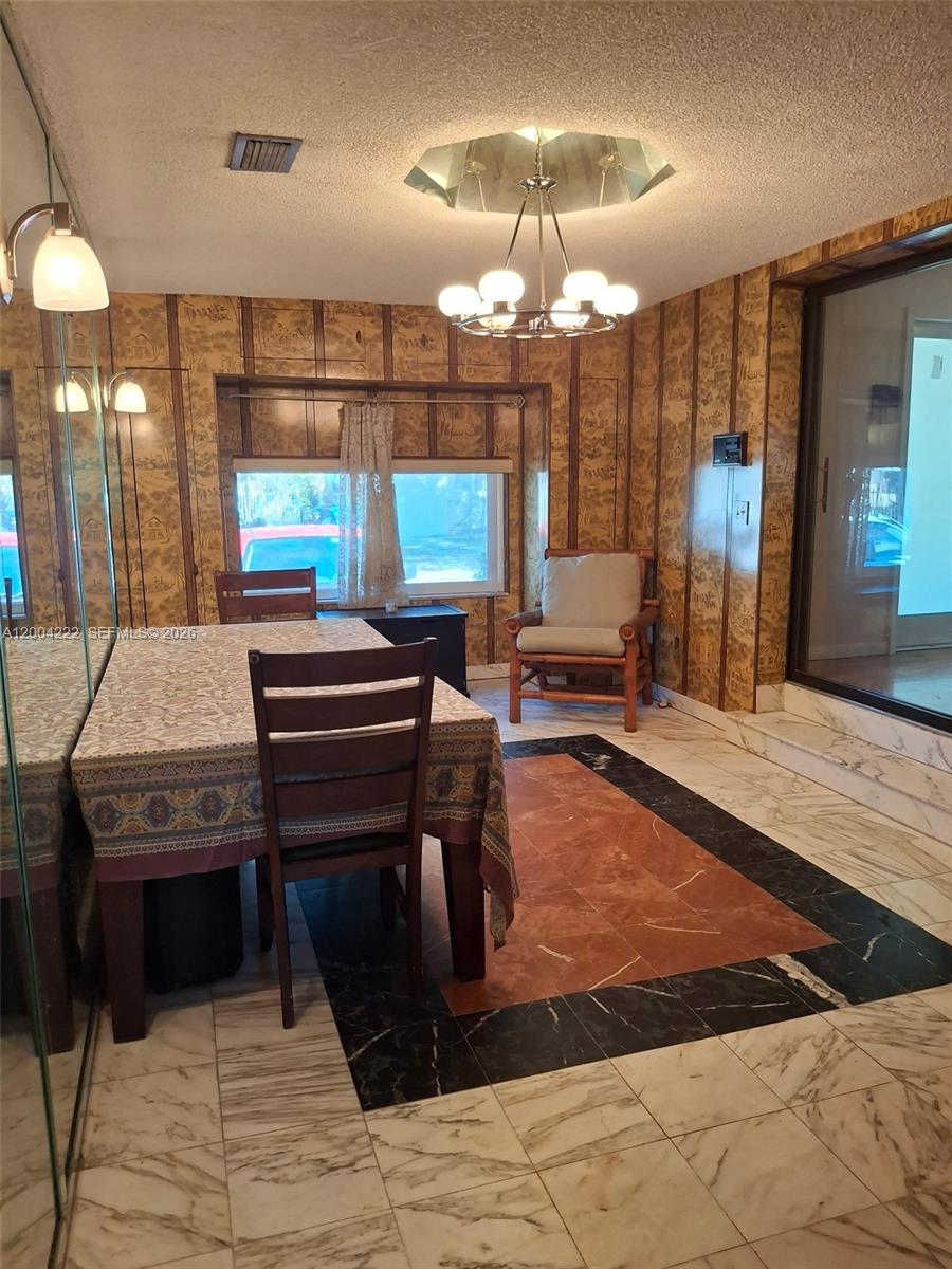 540 Southwest 39th Avenue Miami, FL 33134 - Photo 12 of 48 a room with dining table and chandelier