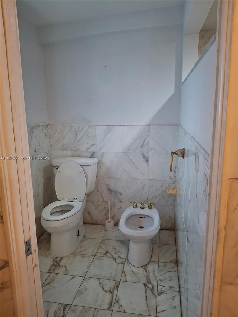 540 Southwest 39th Avenue Miami, FL 33134 - Photo 25 of 48 a white toilet sitting next to a shower curtain