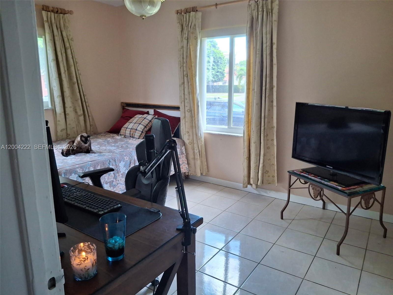 540 Southwest 39th Avenue Miami, FL 33134 - Photo 26 of 48 a bedroom with furniture and a flat screen tv