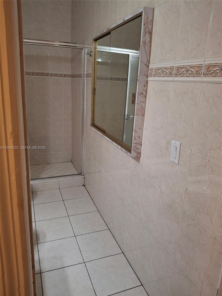 540 Southwest 39th Avenue Miami, FL 33134 - Photo 29 of 48 a bathroom with a glass shower door