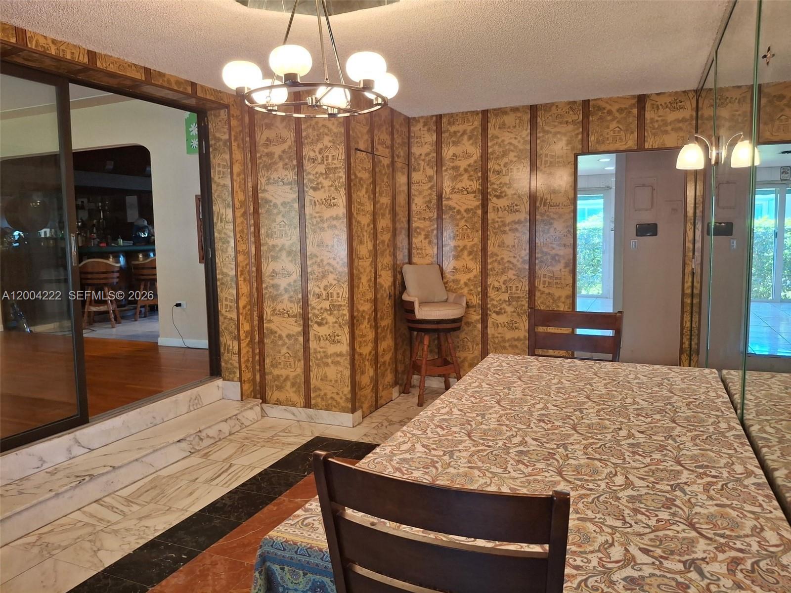 540 Southwest 39th Avenue Miami, FL 33134 - Photo 39 of 48 a bedroom with a large bed and a chandelier