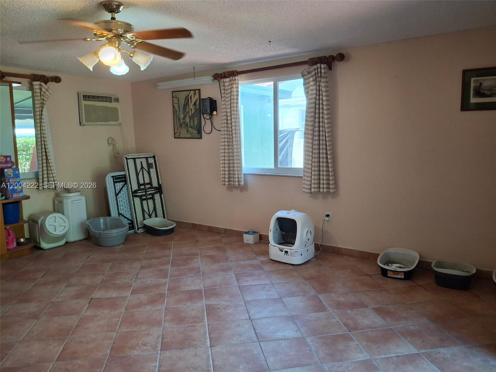 540 Southwest 39th Avenue Miami, FL 33134 - Photo 41 of 48 a view of a room with gym equipment and a chandelier