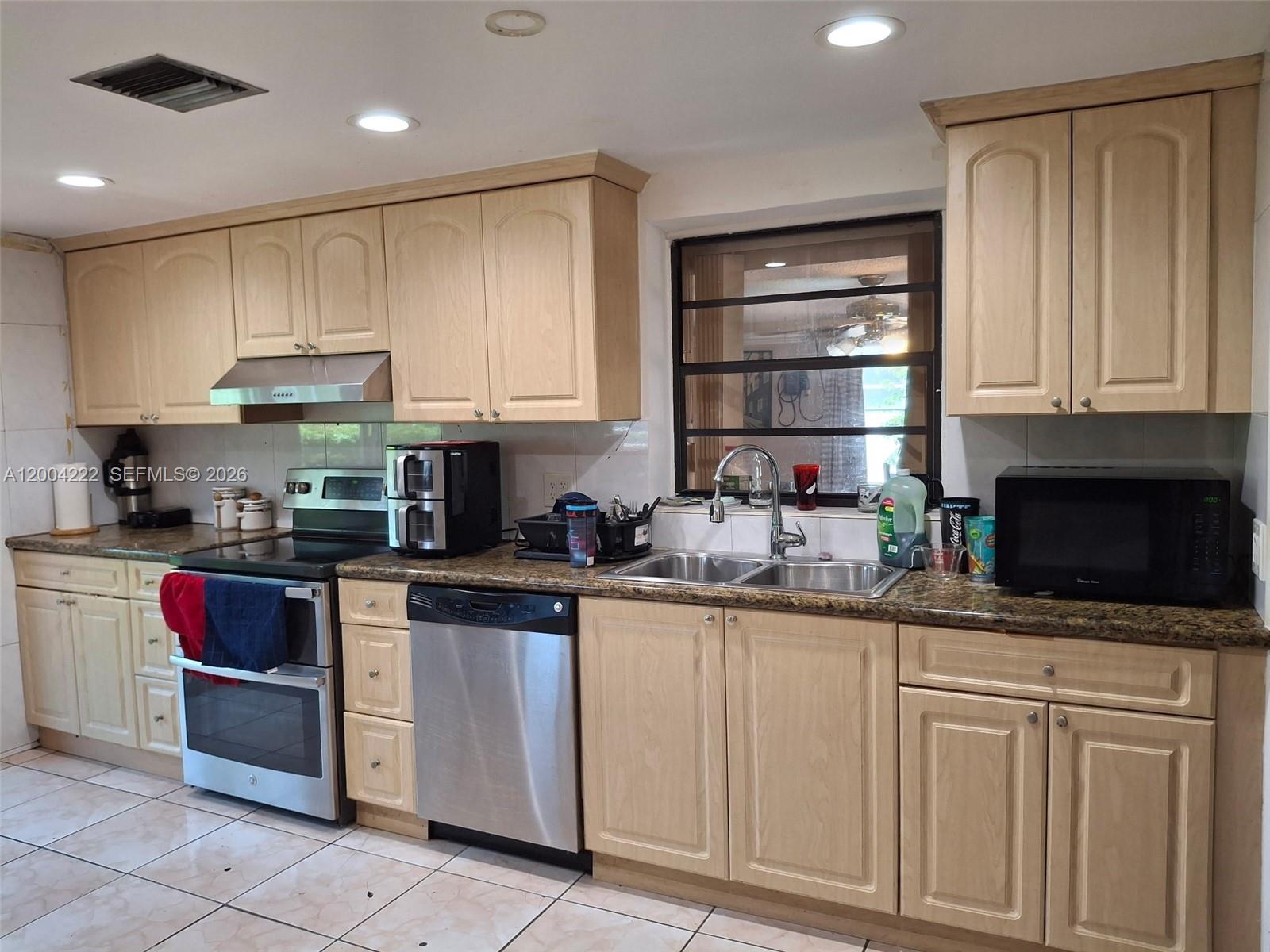540 Southwest 39th Avenue Miami, FL 33134 - Photo 44 of 48 a kitchen with granite countertop a sink stainless steel appliances and cabinets