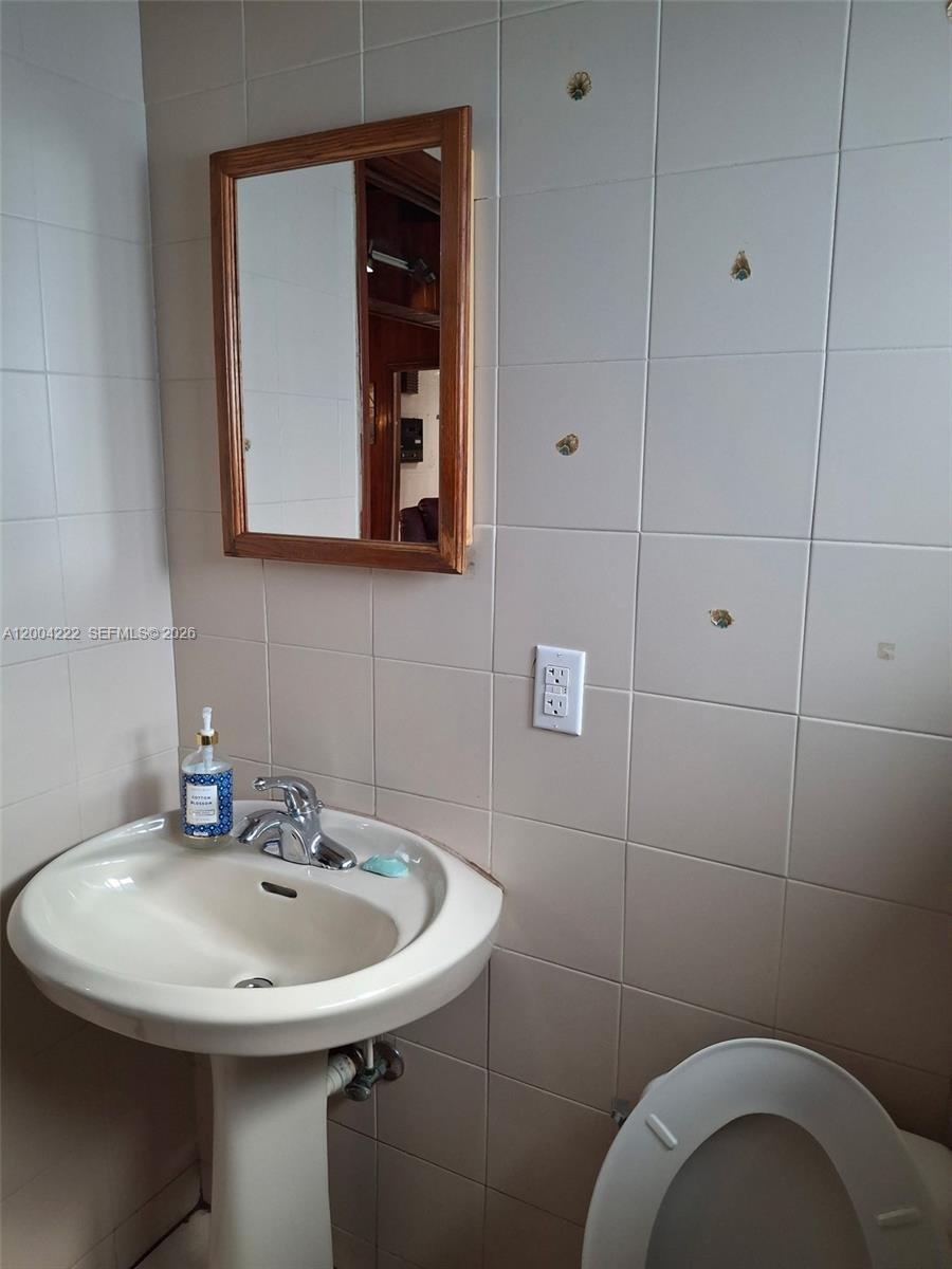 540 Southwest 39th Avenue Miami, FL 33134 - Photo 46 of 48 a bathroom with a sink and a mirror
