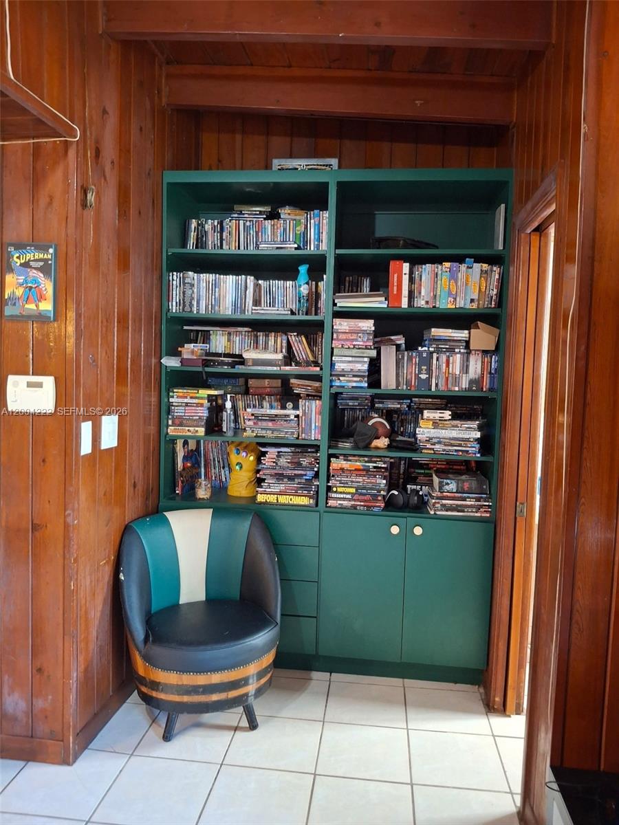 540 Southwest 39th Avenue Miami, FL 33134 - Photo 10 of 48 a living room with furniture a rug and book shelf