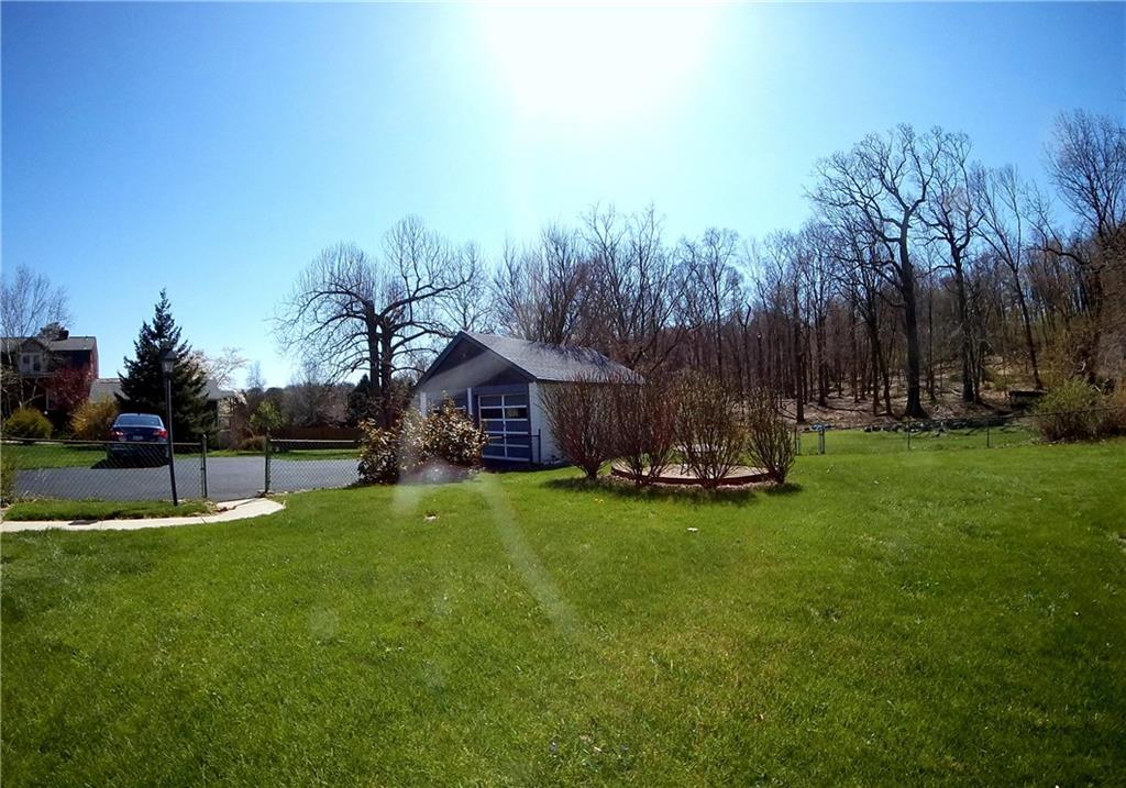 5365 Library Road Bethel Park, PA 15102 - Photo 22 of 25 Park like backyard oasis. 2 Car detached garage matches home exterior as does storage shed behind garage. The wooded area in the back is South Park.