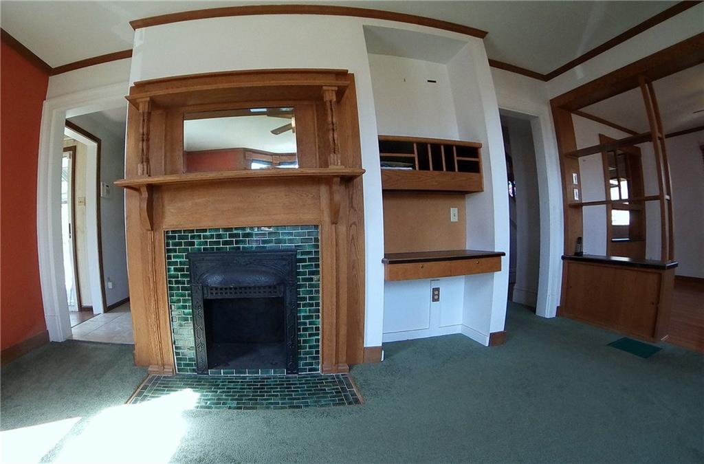 5365 Library Road Bethel Park, PA 15102 - Photo 8 of 25 Gorgeous emerald green tiled fireplace in dining toom is encased with rich oak mantle and mirror.