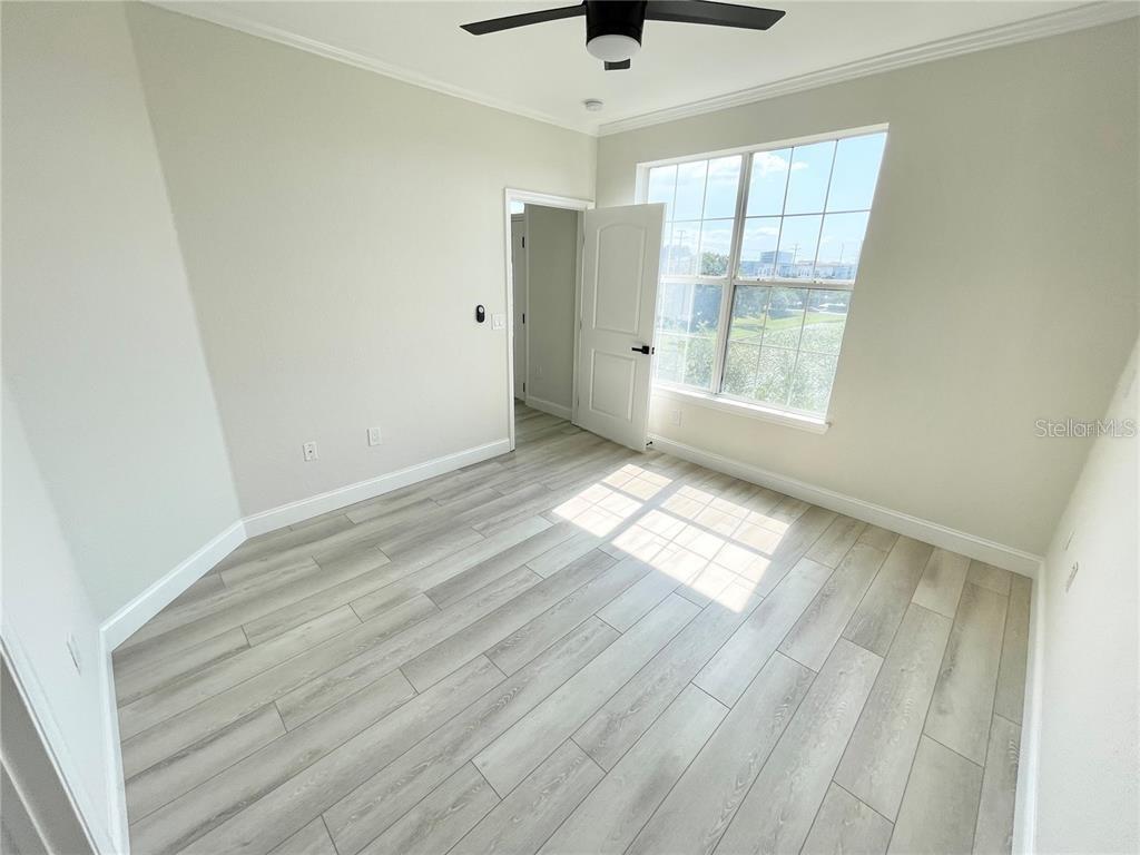 4221 West Spruce Street, Unit 2401 Tampa, FL 33607 - Photo 11 of 22 an empty room with wooden floor and windows
