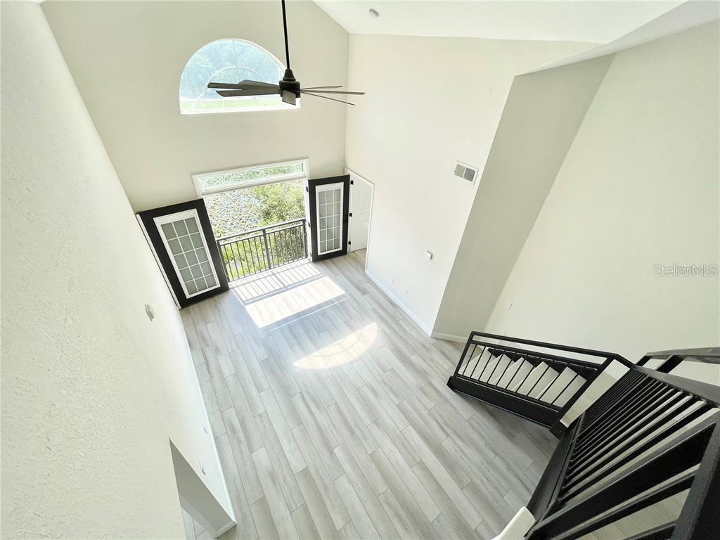 4221 West Spruce Street, Unit 2401 Tampa, FL 33607 - Photo 17 of 22 a view of a hallway with wooden floor and staircase
