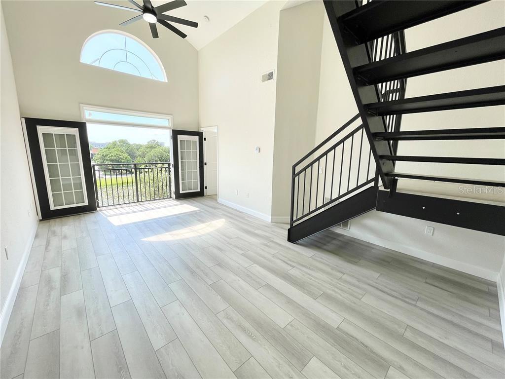 4221 West Spruce Street, Unit 2401 Tampa, FL 33607 - Photo 18 of 22 a view of a room with wooden floor and stairs