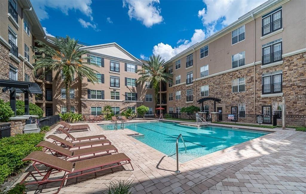 4221 West Spruce Street, Unit 2401 Tampa, FL 33607 - Photo 21 of 22 a view of a building with a yard