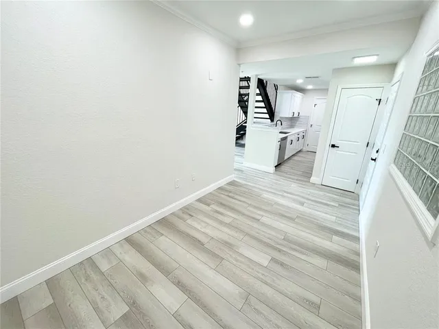 a view of a room with wooden floor