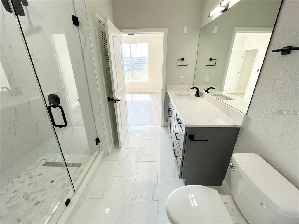 4221 West Spruce Street, Unit 2401 Tampa, FL 33607 - Photo 7 of 22 a bathroom with a sink toilet and shower