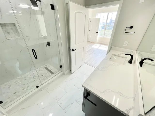 a bathroom with a bathtub and a shower
