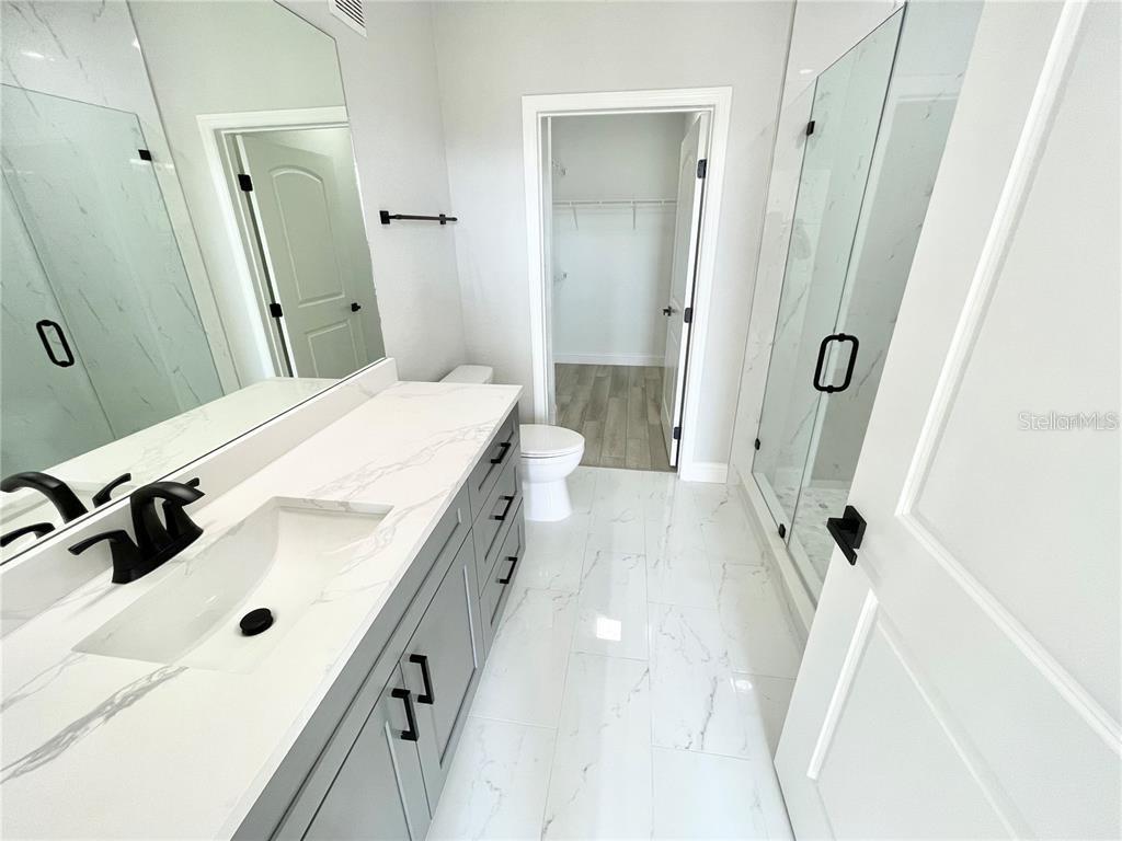 4221 West Spruce Street, Unit 2401 Tampa, FL 33607 - Photo 9 of 22 a bathroom with a tub sink and mirror