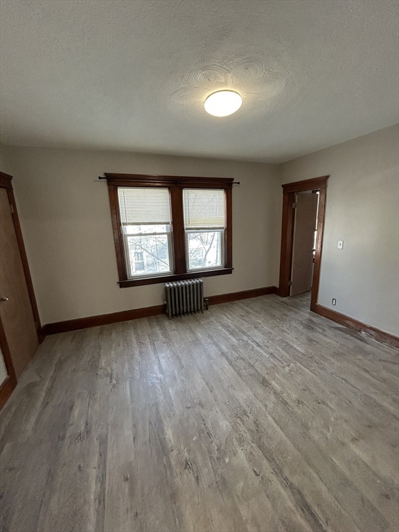 6 Boyden Street, Unit 1F Webster, MA 01570 - Photo 5 of 7 an empty room with wooden floor and windows