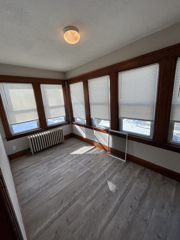 6 Boyden Street, Unit 1F Webster, MA 01570 - Photo 6 of 7 wooden floor in an empty room with a window