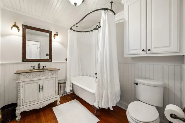 a bedroom with furniture and a wooden floor