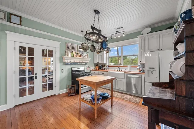 a living room with furniture a fireplace and a large window