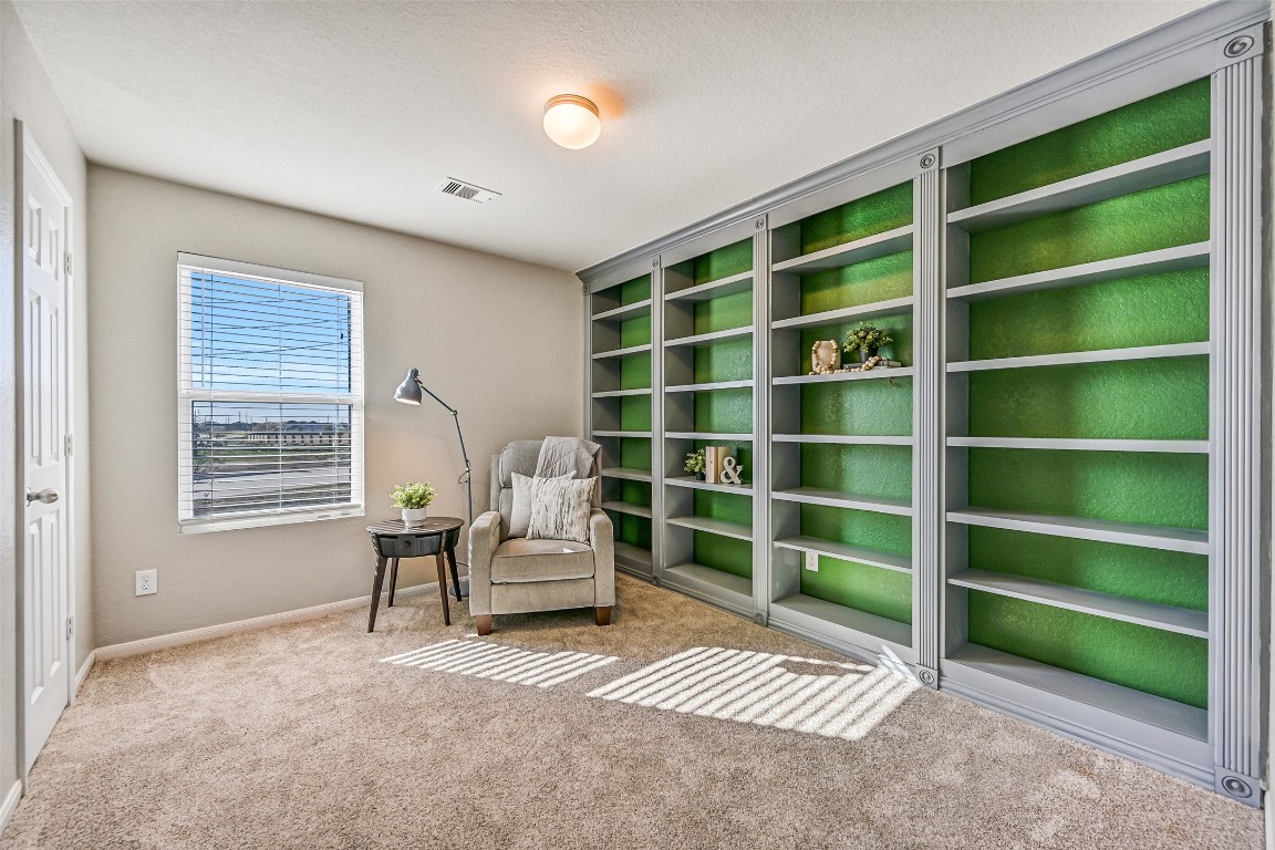 4206 Brightridge Court Rosenberg, TX 77471 - Photo 22 of 27 The final secondary bedroom in the home is currently utilized as a bonus room with plush carpet and a wall of built-in shelving, ideal for a study or hobby room.