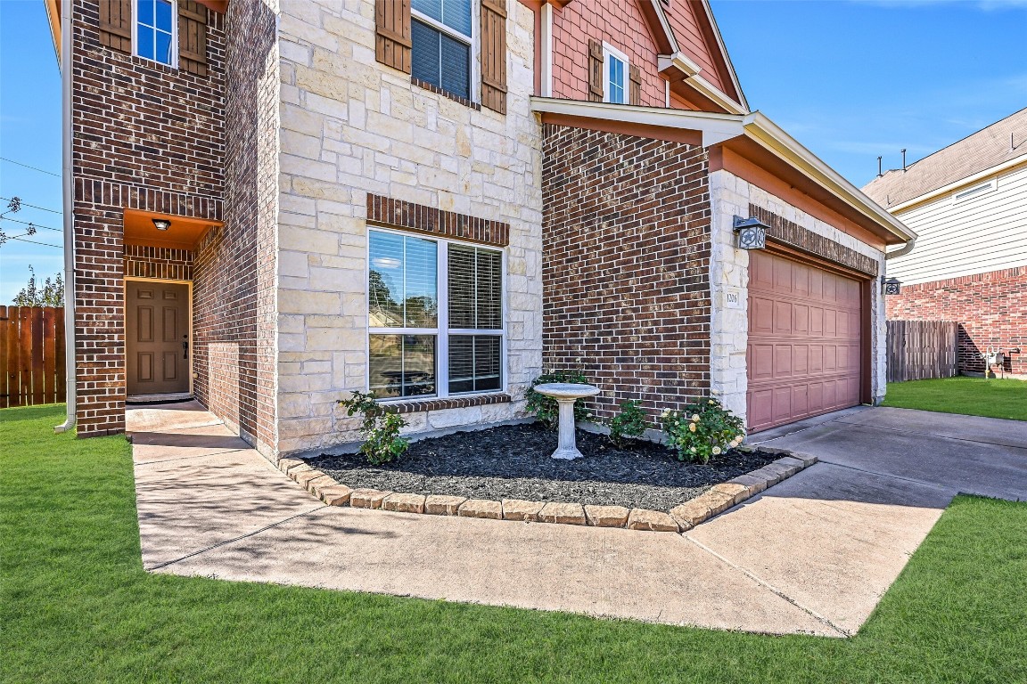 4206 Brightridge Court Rosenberg, TX 77471 - Photo 3 of 27 A sidewalk wraps around the house from the double wide driveway to an inviting front entry with lovely stone accents, freshly mulched landscape beds, and a charming covered porch.