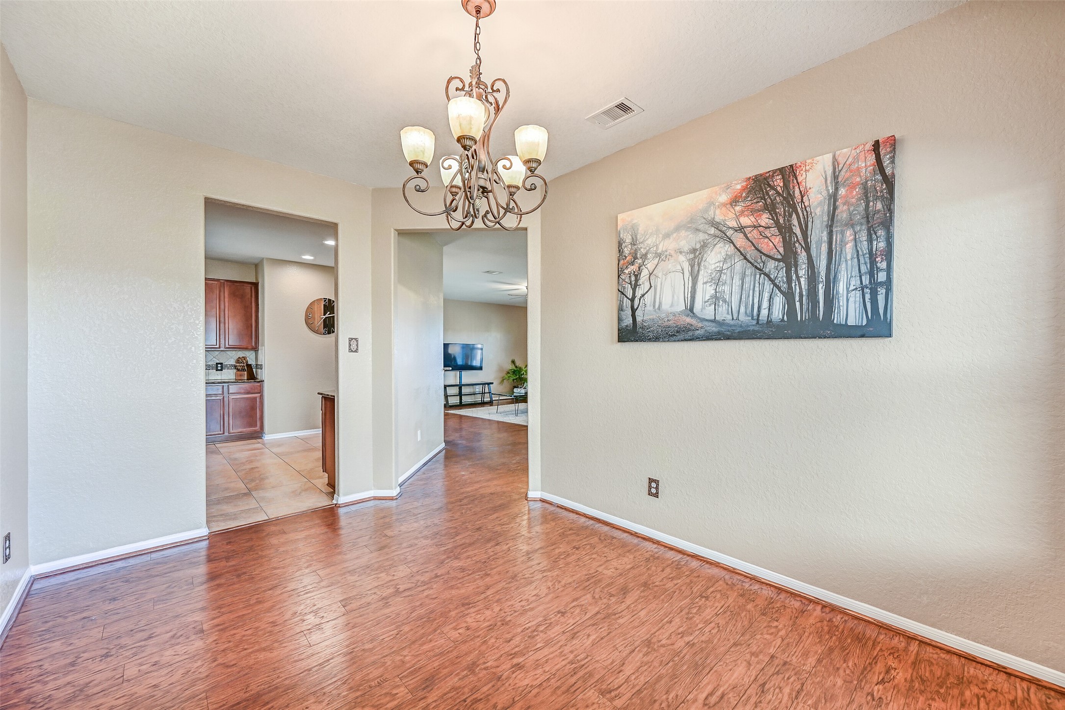 4206 Brightridge Court Rosenberg, TX 77471 - Photo 7 of 27 a view of a hallway with wooden floor and a chandelier
