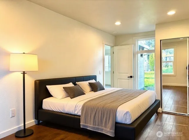 a bedroom with a bed and a lamp