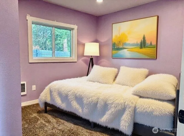 a bedroom with a bed and a painting on the wall