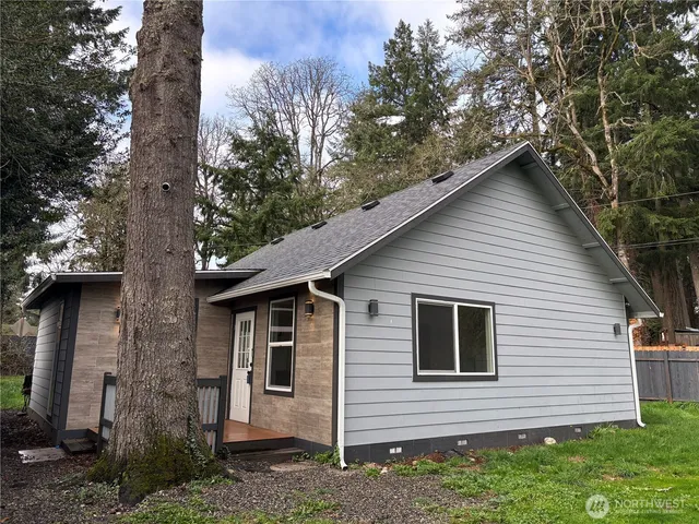 a front view of a house with a garden