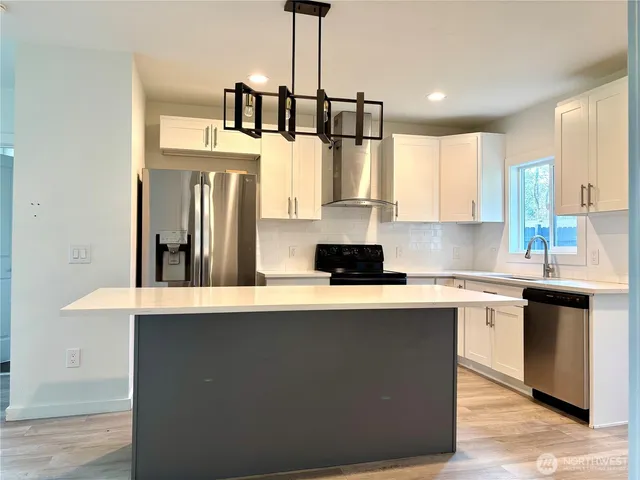a kitchen with stainless steel appliances a sink stove and refrigerator