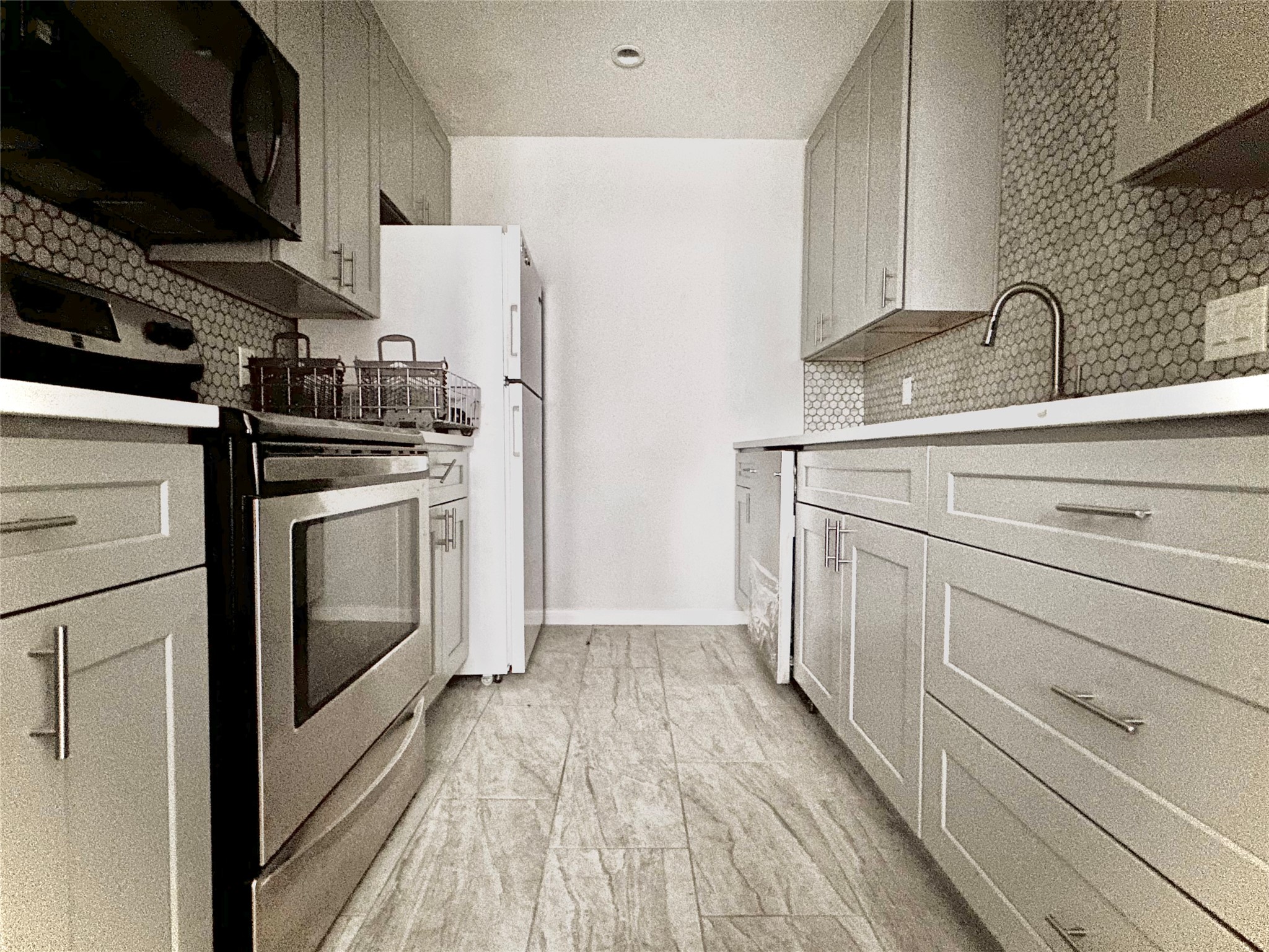 2529 Rio Grande Street, Unit 1 Austin, TX 78705 - Photo 4 of 9 a kitchen with a white cabinets and white appliances