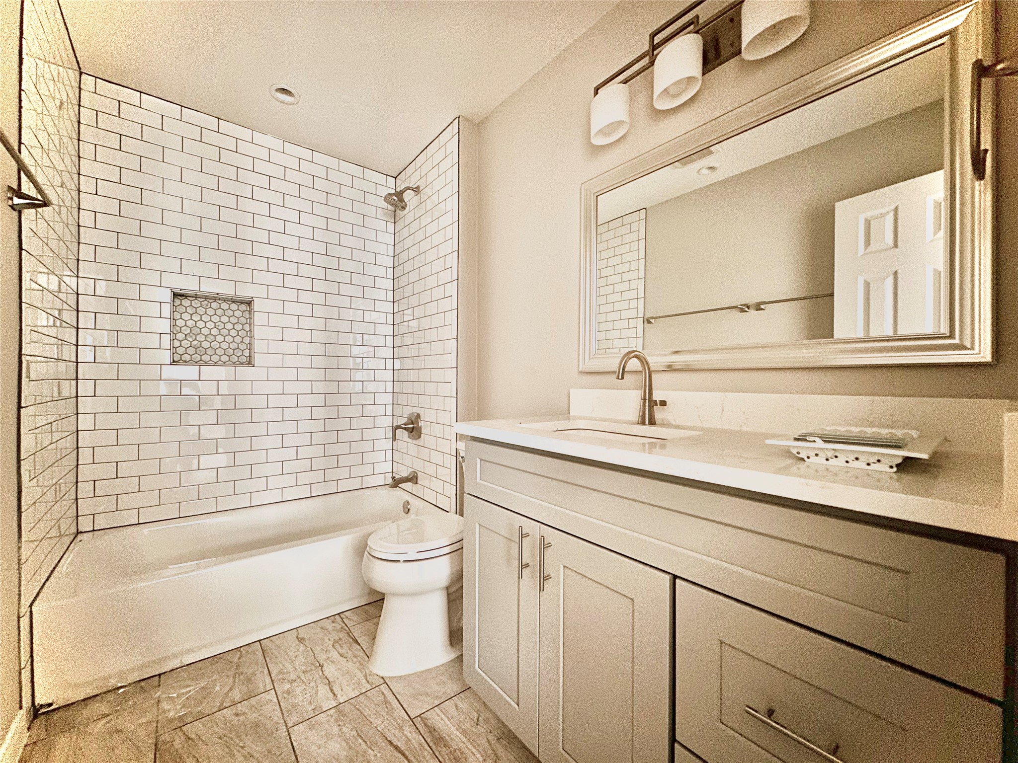 2529 Rio Grande Street, Unit 1 Austin, TX 78705 - Photo 9 of 9 a bathroom with a sink a toilet a mirror a vanity and bathtub