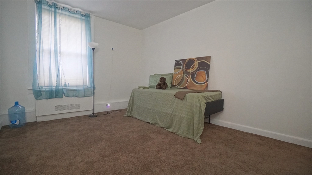 140 Chestnut Street, Unit 314 Springfield, MA 01103 - Photo 11 of 21 a living room with furniture and a window