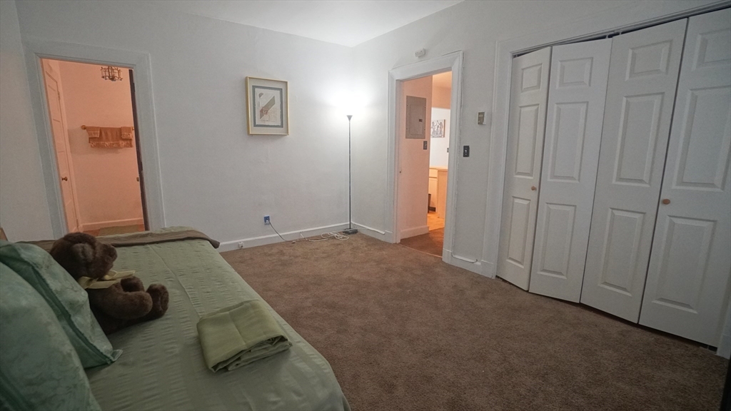 140 Chestnut Street, Unit 314 Springfield, MA 01103 - Photo 13 of 21 a bedroom with a bed and a window