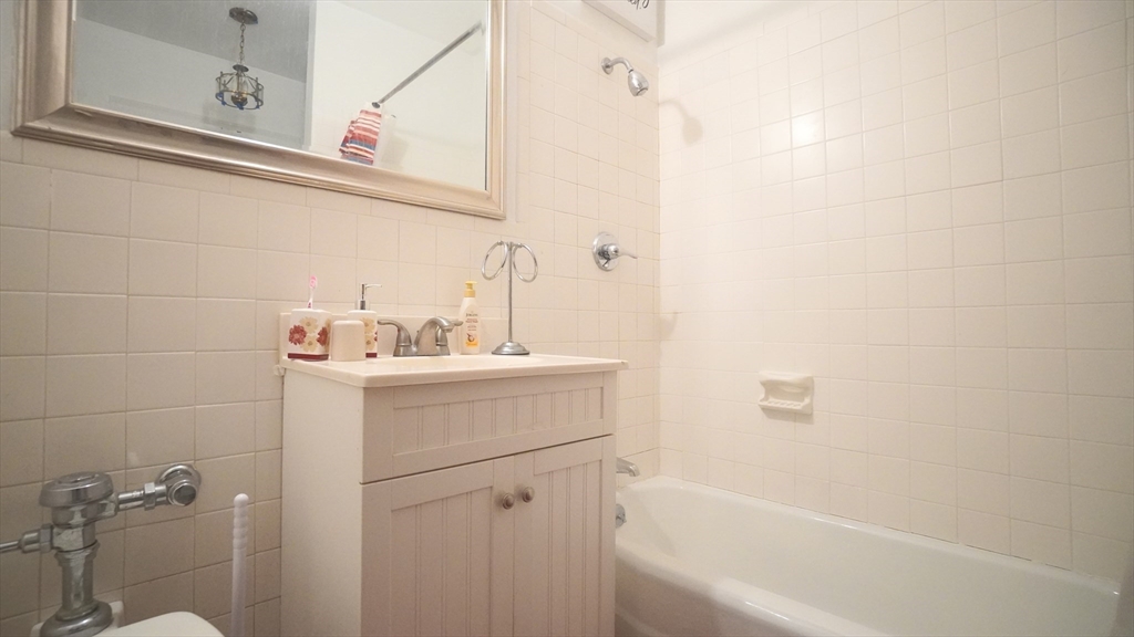 140 Chestnut Street, Unit 314 Springfield, MA 01103 - Photo 15 of 21 a bathroom with a sink a toilet and shower