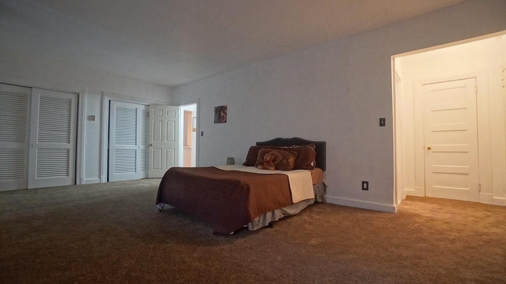 140 Chestnut Street, Unit 314 Springfield, MA 01103 - Photo 17 of 21 a spacious bedroom with a bed and a window