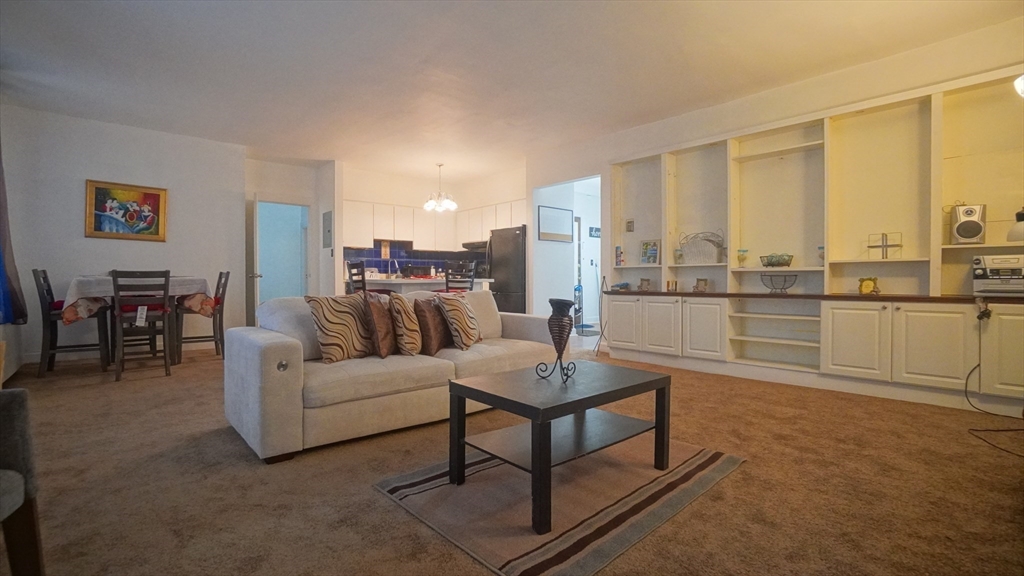 140 Chestnut Street, Unit 314 Springfield, MA 01103 - Photo 3 of 21 a living room with furniture and a floor to ceiling window