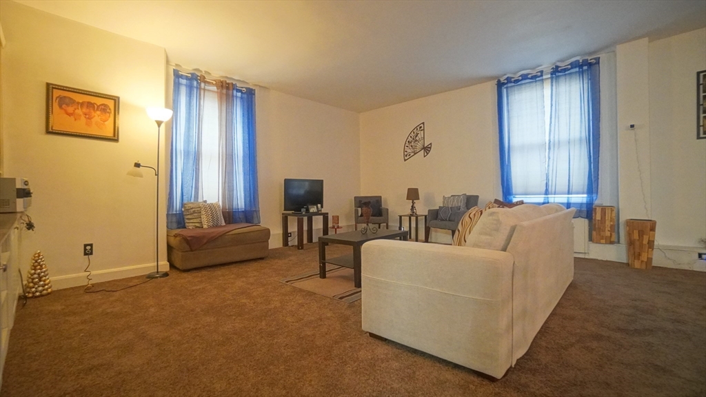 140 Chestnut Street, Unit 314 Springfield, MA 01103 - Photo 4 of 21 a living room with furniture and a large window