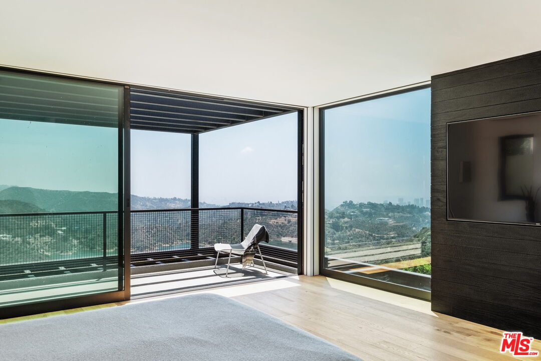 2200 Stradella Road Los Angeles, CA 90077 - Photo 11 of 27 a view of a room with wooden floor and windows