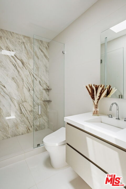 2200 Stradella Road Los Angeles, CA 90077 - Photo 14 of 27 a bathroom with a granite countertop sink a toilet and a mirror