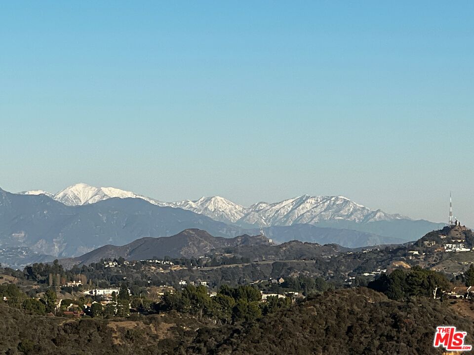 2200 Stradella Road Los Angeles, CA 90077 - Photo 19 of 27 a view of a mountain range in a cloudy sky